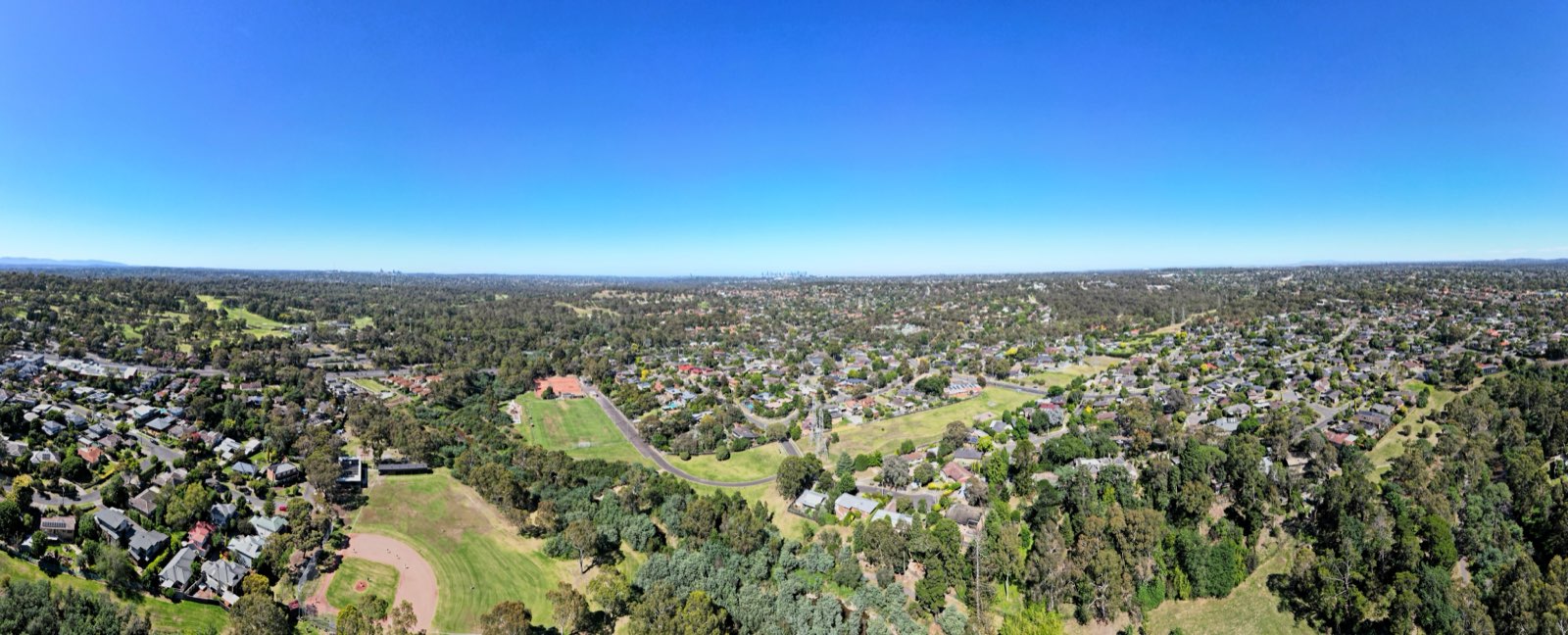 Aerial view over the Plenty valley near Montmorency looking toward the Melbourne city skyline